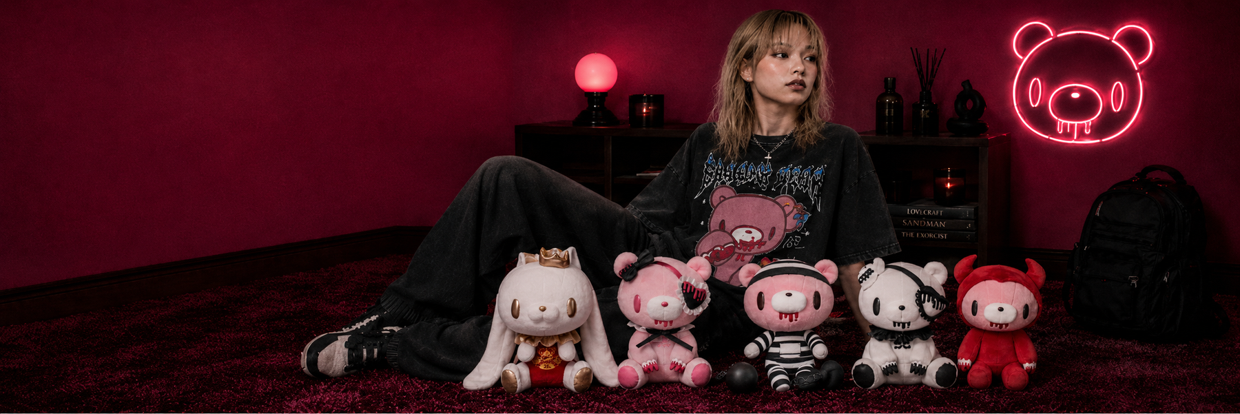 gloomy bear model laying in bed with plushies